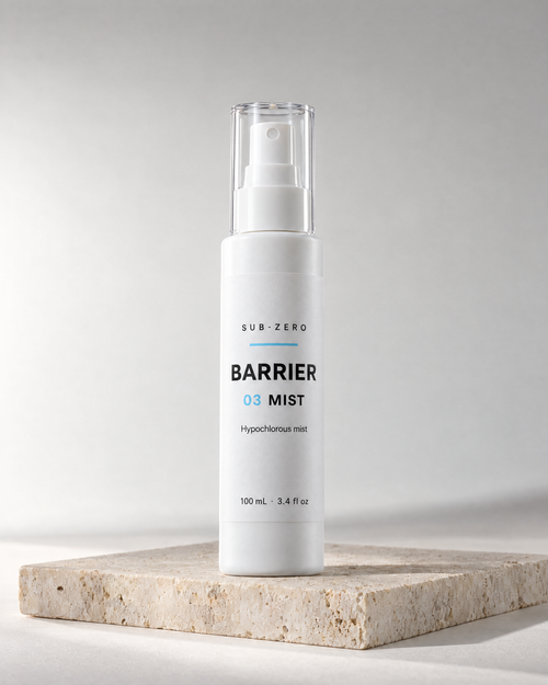 BARRIER Mist hypochlorous acid spray in a 100 ml white bottle by Sub-Zero, on travertine in studio light