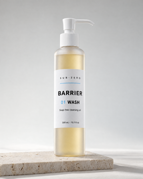 BARRIER Wash soap-free cleansing oil in a 300 ml frosted pump bottle by Sub-Zero, on travertine in studio light