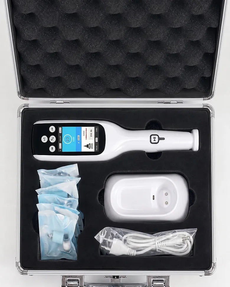 Apex aluminium case from above — device, charging stand, treatment heads and cable in cut foam