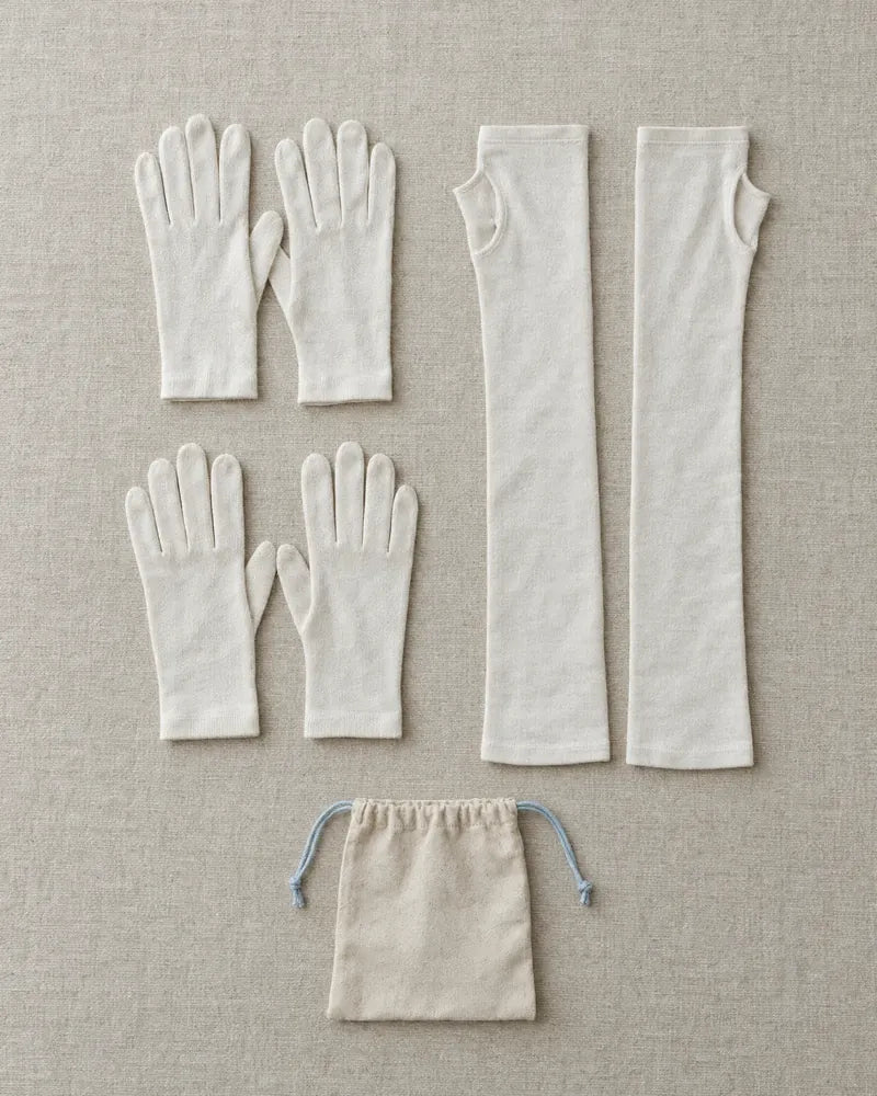 The Night Kit laid out: two pairs of cotton sleep gloves, cotton arm sleeves and a pouch